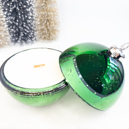 Green glass Christmas ornament candle on a white background