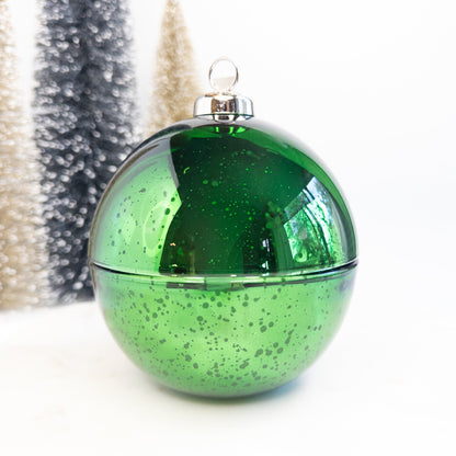 Green speckled Christmas ornament candle on a white background