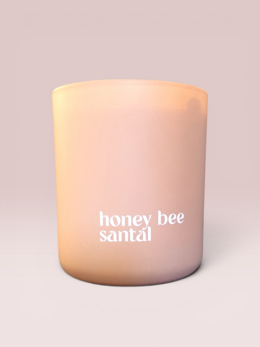 Honey Bee Santal 9 oz double-wick candle in a matte khaki glass vessel.