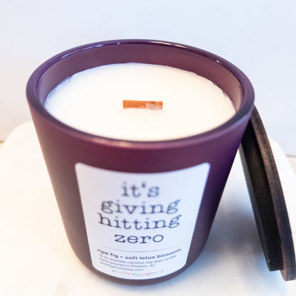 it's giving hitting zero candle in a matte plum container with a label on a white background