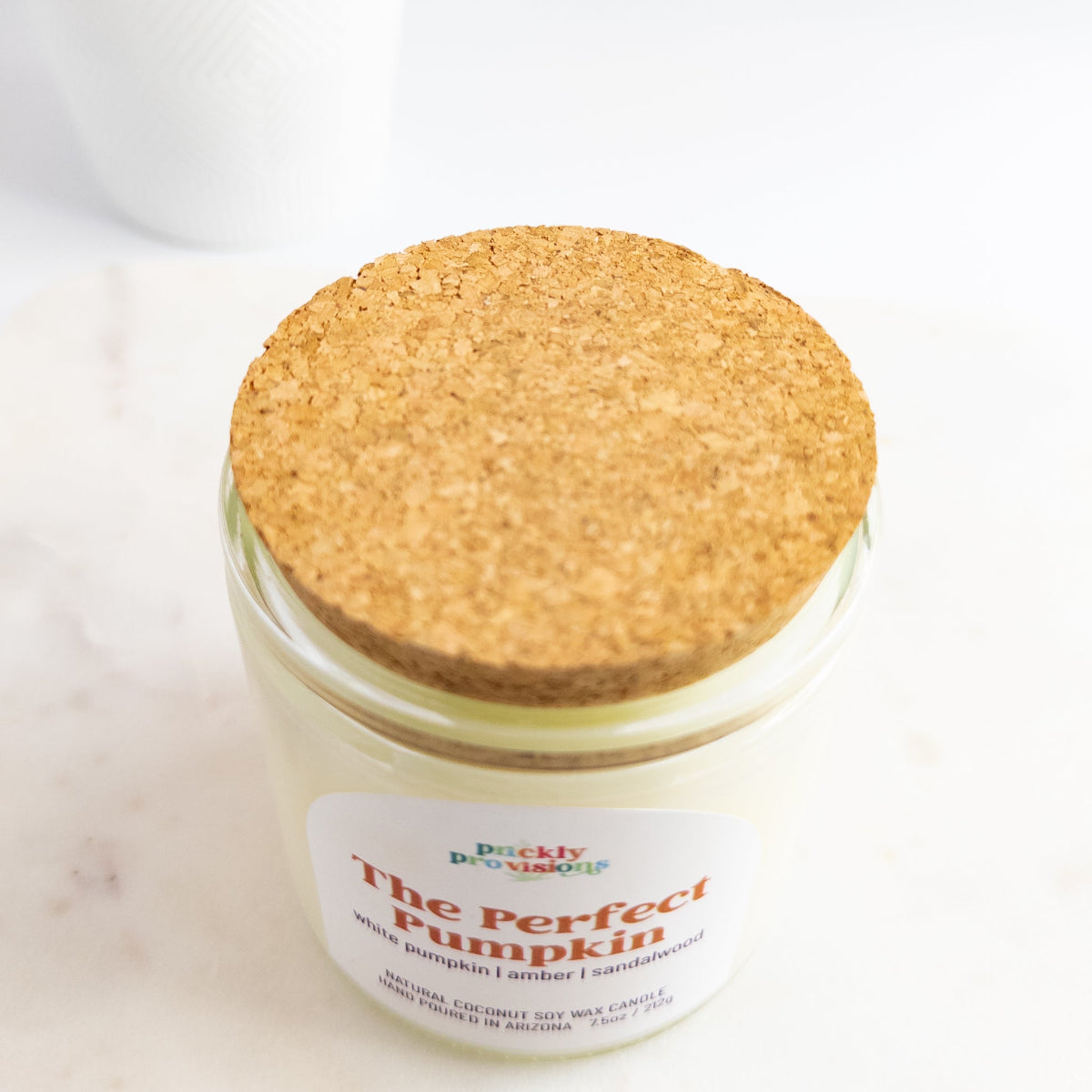 Jar of 'The Perfect Pumpkin' candle with a cork lid on a white background