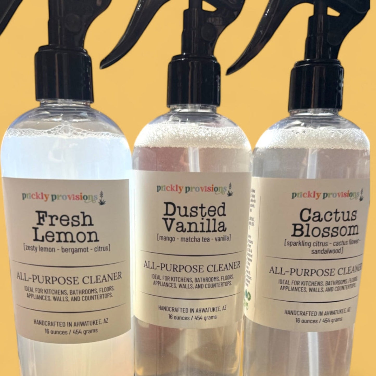 Fresh Lemon, Dusted Vanilla, and Cactus Blossom all-purpose cleaners on a yellow background