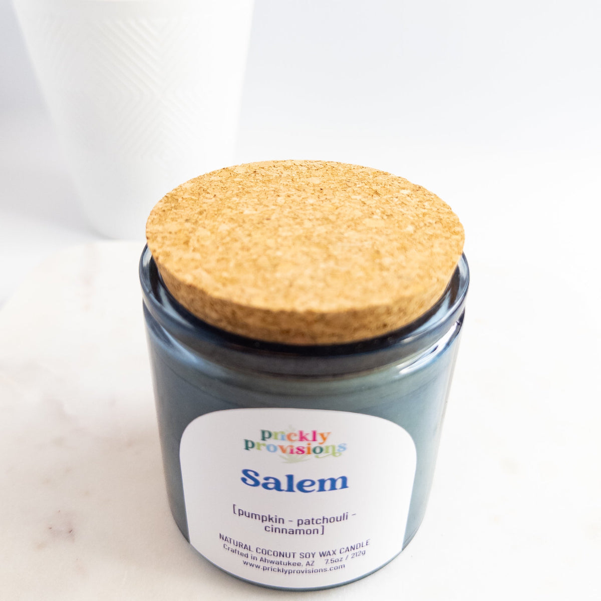 Jar candle labeled 'Salem' with a cork lid on a white background