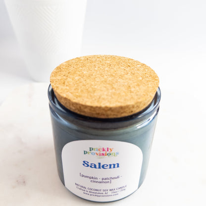 Jar candle labeled 'Salem' with a cork lid on a white background