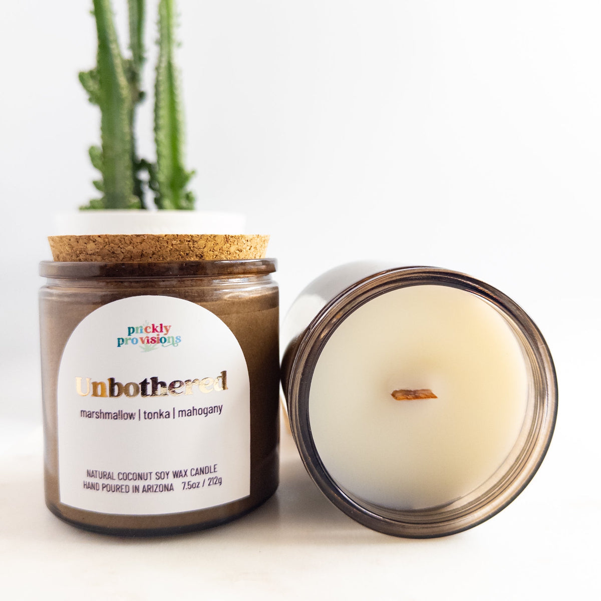 Candle with a cork lid and visible label on a white background