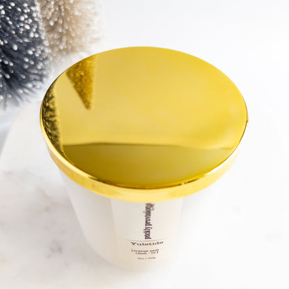 Gold-topped container with a white label on a light background